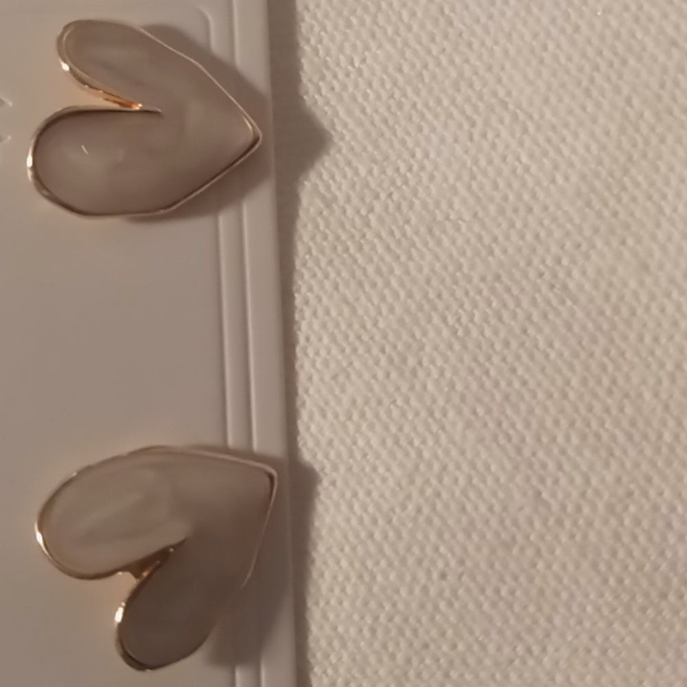 Heart earrings Gold tone with a pearl white swirl inlay .studs